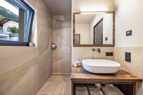 a bathroom with a sink and a mirror at Apartment 16 cityview in Cornedo all'Isarco