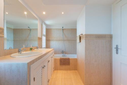 a bathroom with a sink and a bath tub at Fuengirola Hills with Seaview in Fuengirola