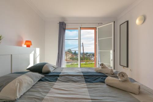 a bedroom with a large bed with towels on it at Fuengirola Hills with Seaview in Fuengirola
