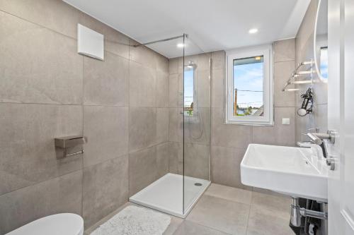 a bathroom with a shower and a sink and a toilet at Villa Jäger mit Pool in Wien in Vienna