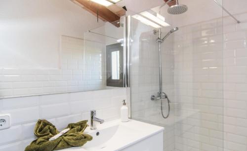 a white bathroom with a sink and a mirror at Finca Sa Real in Cala Millor