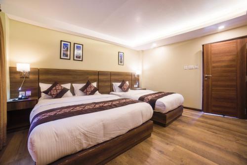 a hotel room with two beds in it at Hotel Thakali Inn in Kathmandu
