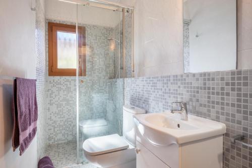 a bathroom with a toilet and a sink and a shower at Casa Mediterranea in Cala Santanyi