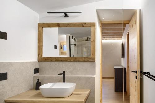 a bathroom with a sink and a mirror at Dimora Vacanze in Mezzano