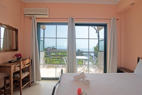 a bedroom with a bed and a view of the ocean at Andromaches large apartment in Virós