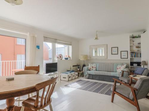 a living room with a table and a couch at 1 Bay View Court in Lyme Regis