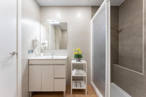 a white bathroom with a sink and a shower at Apartment Mijas Sun and Beach in Sitio de Calahonda