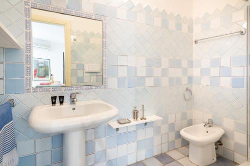 a bathroom with a sink and a toilet at Nido in Monte Petrosu