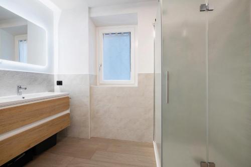 a bathroom with a shower and a sink at Cà De Qualì in Costa Volpino