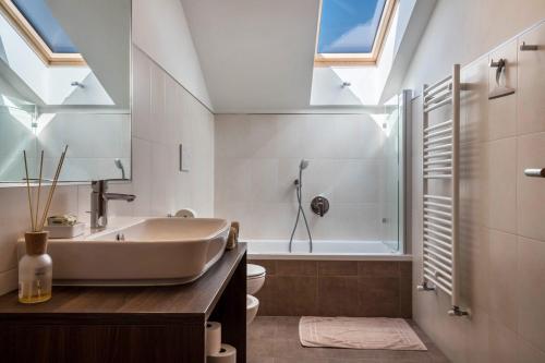 a bathroom with a tub and a sink and a toilet at Mongaduierhof Apt Schlern in Fie allo Sciliar