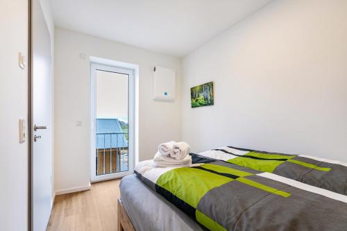 a bedroom with a bed with a towel on it at Snorrum Wohnung 7 in Husby