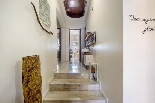 a hallway with a staircase with wood floors and a ceiling at Sobreiro22 in Lourosa