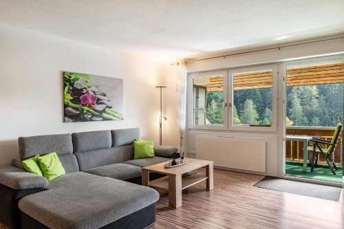 a living room with a couch and a table at Ferienwohnung Ursel in Todtmoos