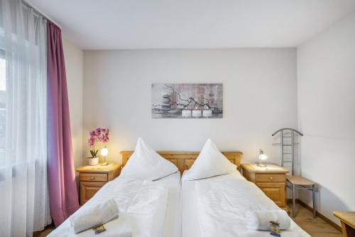 a bedroom with two beds with white sheets at Fewo mit Bergblick, Pool, Sauna in Oberaudorf