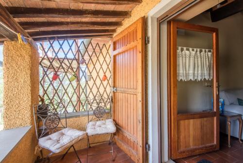 a room with a balcony with a door and a window at Glicine in Montieri