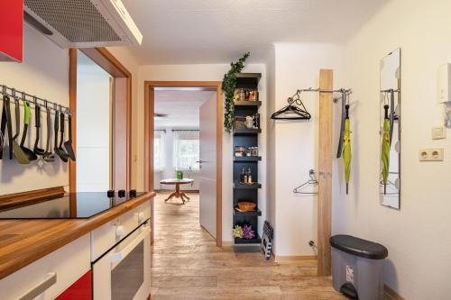 a kitchen with utensils hanging on the wall at Ferienwohnung Blumen in Radeberg