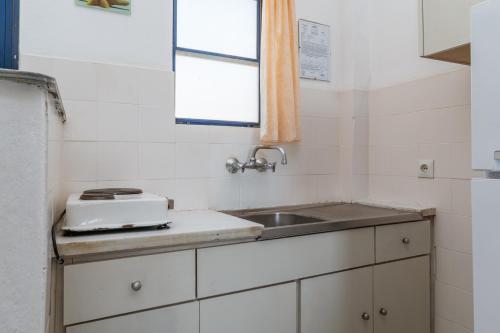 a small kitchen with a sink and a window at Perasma Studio 1a in Kipri