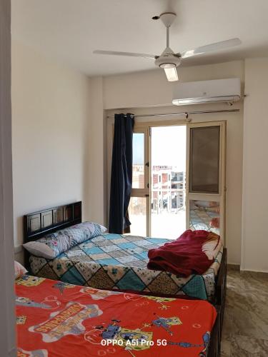 a bedroom with two beds and a window at 2 rooms, 2 balconies in Marsa Alam City