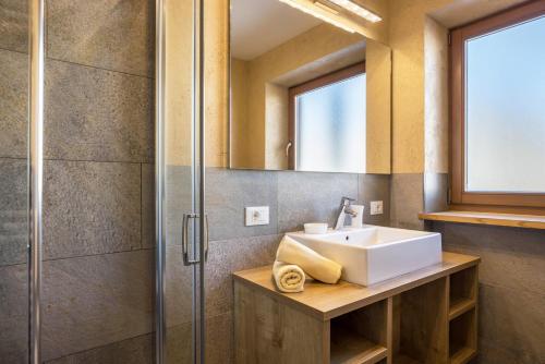 a bathroom with a sink and a shower at Rosalpina Apt 4 in San Vigilio Di Marebbe