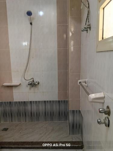 a bathroom with a shower with a toilet and a sink at 2 rooms, 2 balconies in Marsa Alam City