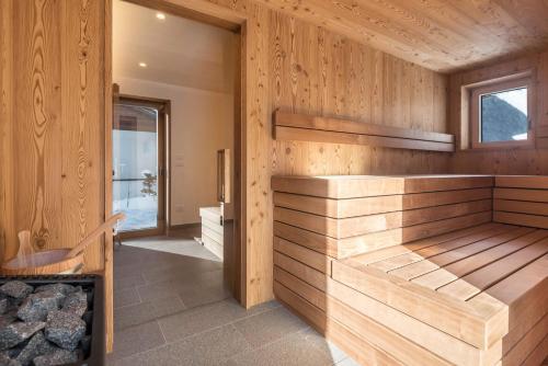 a room with a fireplace in a wooden house at La Grambla App Sella 1 in Santa Cristina Gherdëina