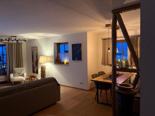 a living room with a couch and a table at Ferienwohnung Vilstalstüble in Pfronten