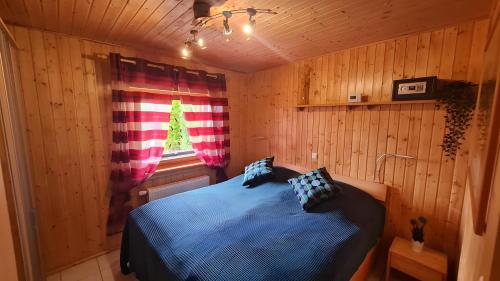 a bedroom with a bed in a wooden room at Ferienhaus Burg Celle in Celle