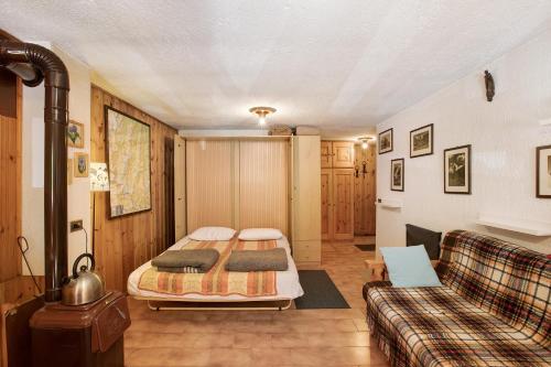 a living room with a bed and a couch at Lo Peiglo Valgrisenche in Valgrisenche