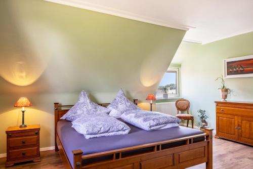 a bedroom with a bed with purple sheets and pillows at Ferienhaus Barockhaus Fulda in Petersberg