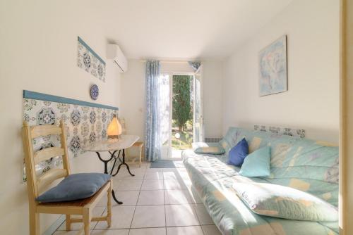 a living room with a couch and a table at Chambres D'hôtes in Saint-Cyprien