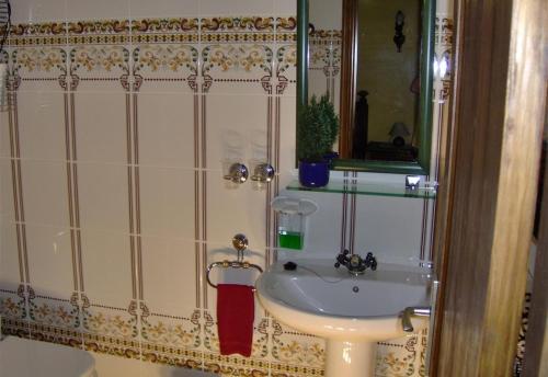 a bathroom with a white sink and a mirror at Aptos Monasterio de San Antonio 4 in Icod de los Vinos