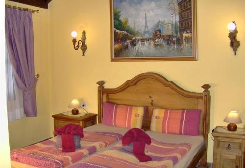 a bedroom with a bed with hats on it at Aptos Monasterio de San Antonio 4 in Icod de los Vinos