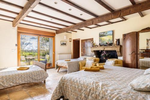 a bedroom with two beds and a fireplace at Bourdeverre Chambres D'hôtes in Sanxay