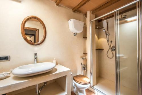 a bathroom with a sink and a toilet and a shower at Appartamento Gemma Bianca-tavoleto in Castiglione dʼOrcia