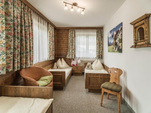 a hotel room with a bedroom with a bed and a couch at Wolfbachgut - Ferienwohnung 1 in Taxenbach