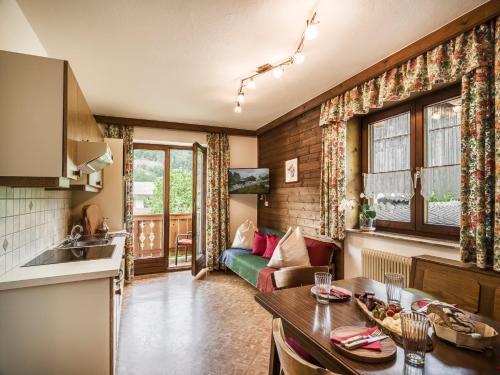 a kitchen and a living room with a table at Wolfbachgut - Ferienwohnung 1 in Taxenbach