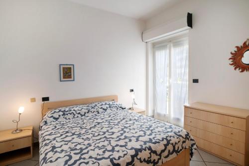 a bedroom with a bed and a large window at Mirafiori in Alassio