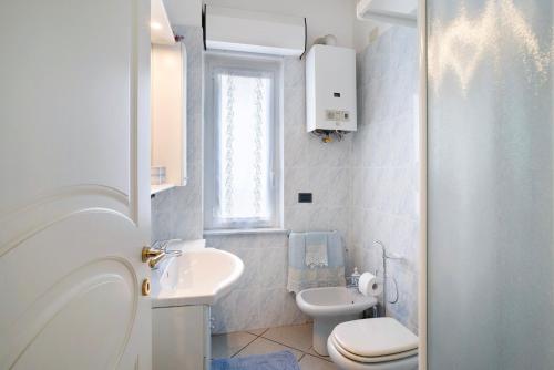a white bathroom with a sink and a toilet at Mirafiori in Alassio
