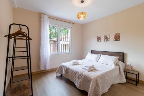 a bedroom with a bed with a ladder and a window at Susurros de río in Ocejo