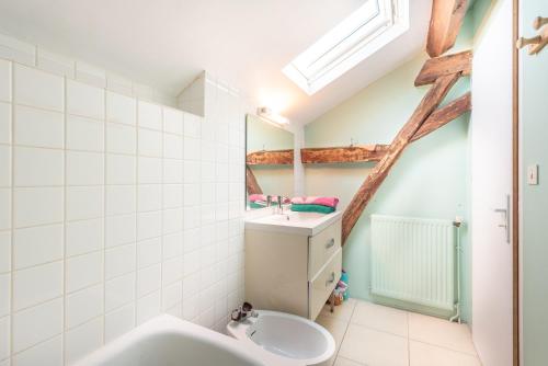 a bathroom with a sink and a mirror at Maison Blousson, Longère gersoise in Malabat