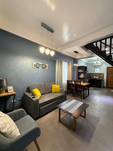 a living room with a couch and a table at Luxea Flexstay II - Spacious Duplex Home in San Francisco