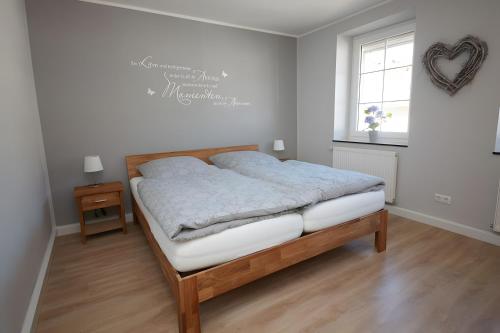a bedroom with a bed and a window at Ferienhaus Eifelträume, Birresborn in Birresborn