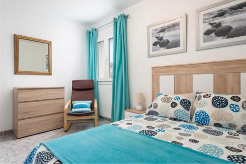 a bedroom with a bed and a chair at Can Navarro in Llucmajor