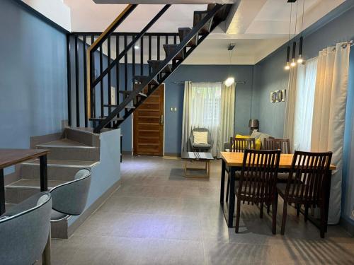 a dining room with a table and a staircase at Luxea Flexstay II - Spacious Duplex Home in San Francisco