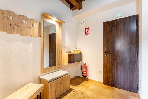 a room with a wooden door and a fire hydrant at Entre Eras Apto Rural Los Vencejos in Ademuz