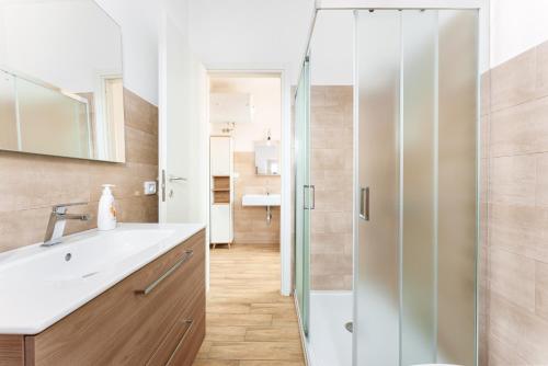 a bathroom with a sink and a shower at Enjoy The Silence Flat in Orosei