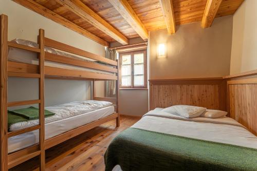 two bunk beds in a room with wooden ceilings at Civico 12 in Marmora