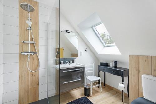 a bathroom with a sink and a desk in a attic at Chambres D'hôtes Les Goélands in Saint-Cast-le-Guildo
