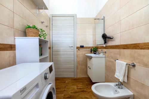 a bathroom with a washing machine and a sink at Casa Rinascita con Piscina Privata in Nulvi