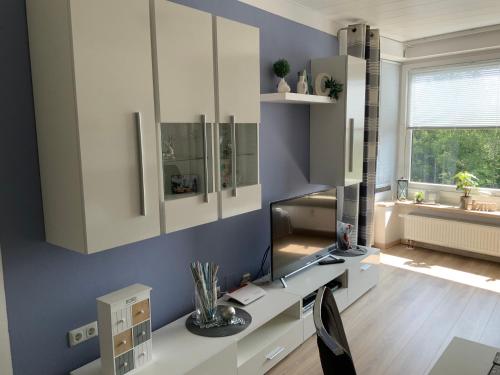 a room with white cabinets and a desk with a window at Fuchsenstein 44 in Oberkreuzberg